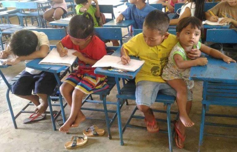 Belajar di sekolah sambil memangku adiknya semangat anak ini bikin kagum